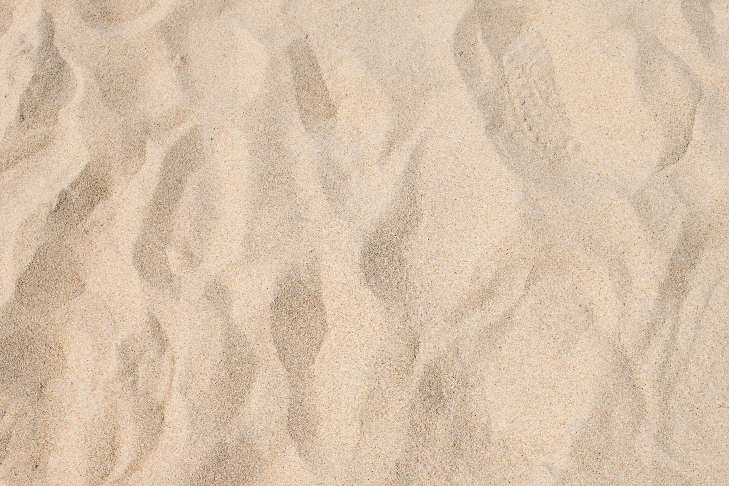 closeup of sand pattern of a beach in the summer
