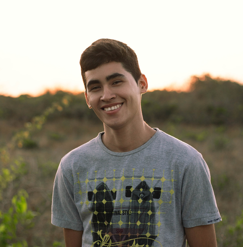 Cheerful young man standing in countryside